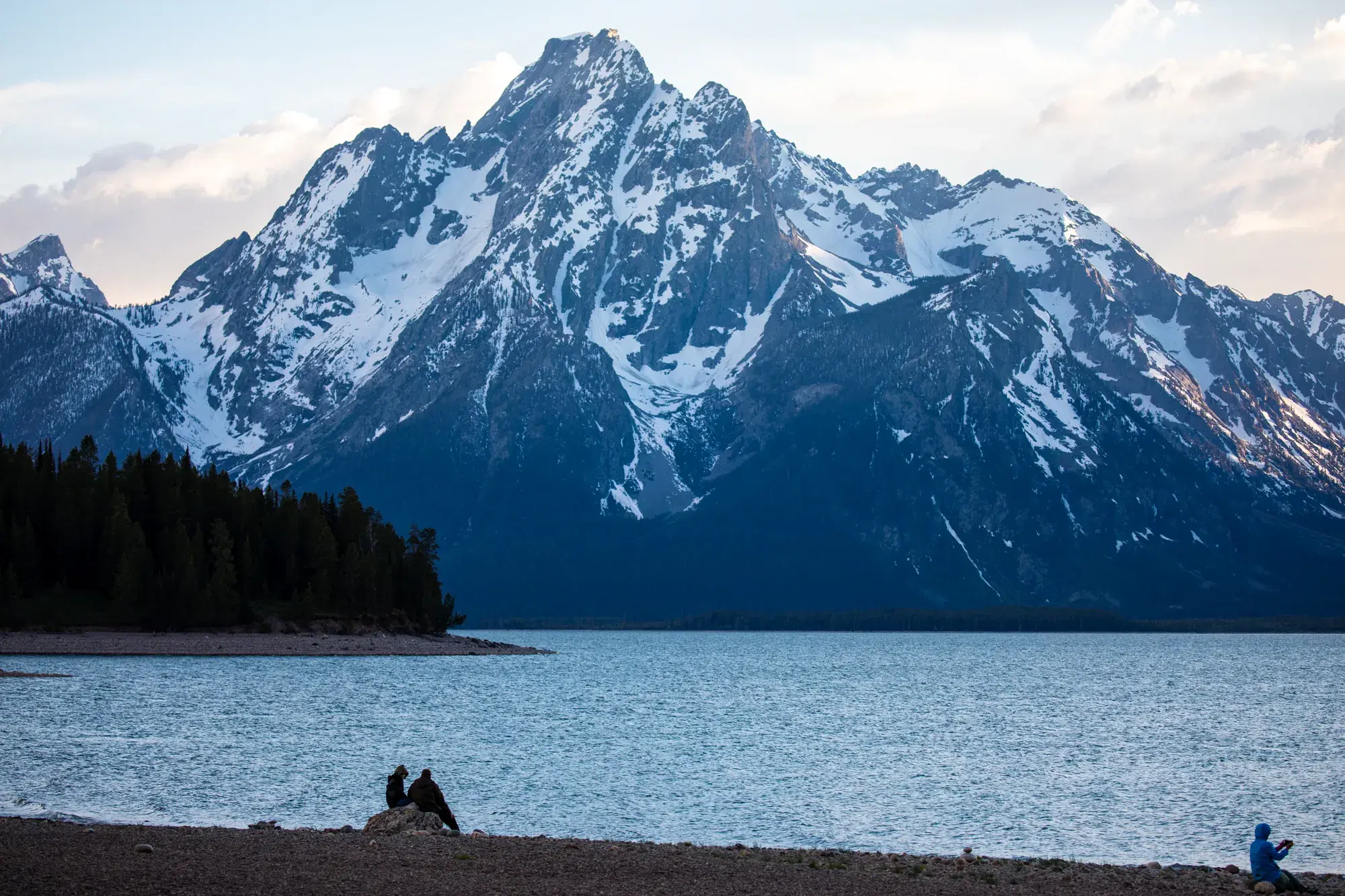 Snow-capped peaks rising over a still mountain lake